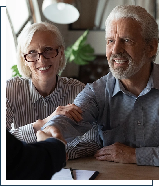 Happy grateful elderly couple of clients thanking real estate lawyer