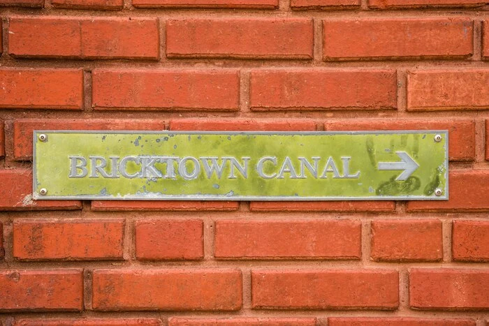 Sign reading Bricktown Canal in the famous tourist district in downtown Oklahoma City, Oklahoma, United States.