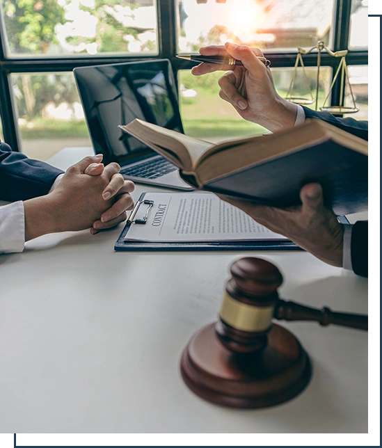 Businessmen and lawyers discuss contract documents.